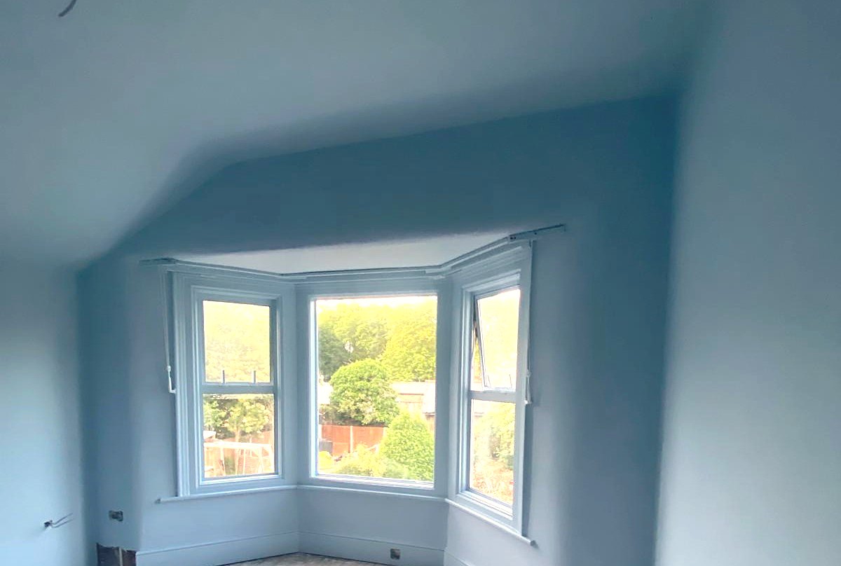 Soft blue bedroom with bay window