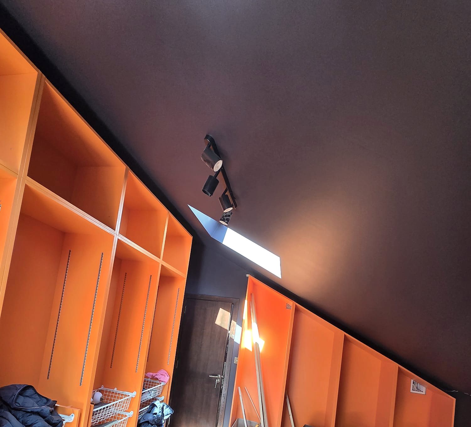 Orange wardrobes under an aubergine ceiling, painted by Zakro