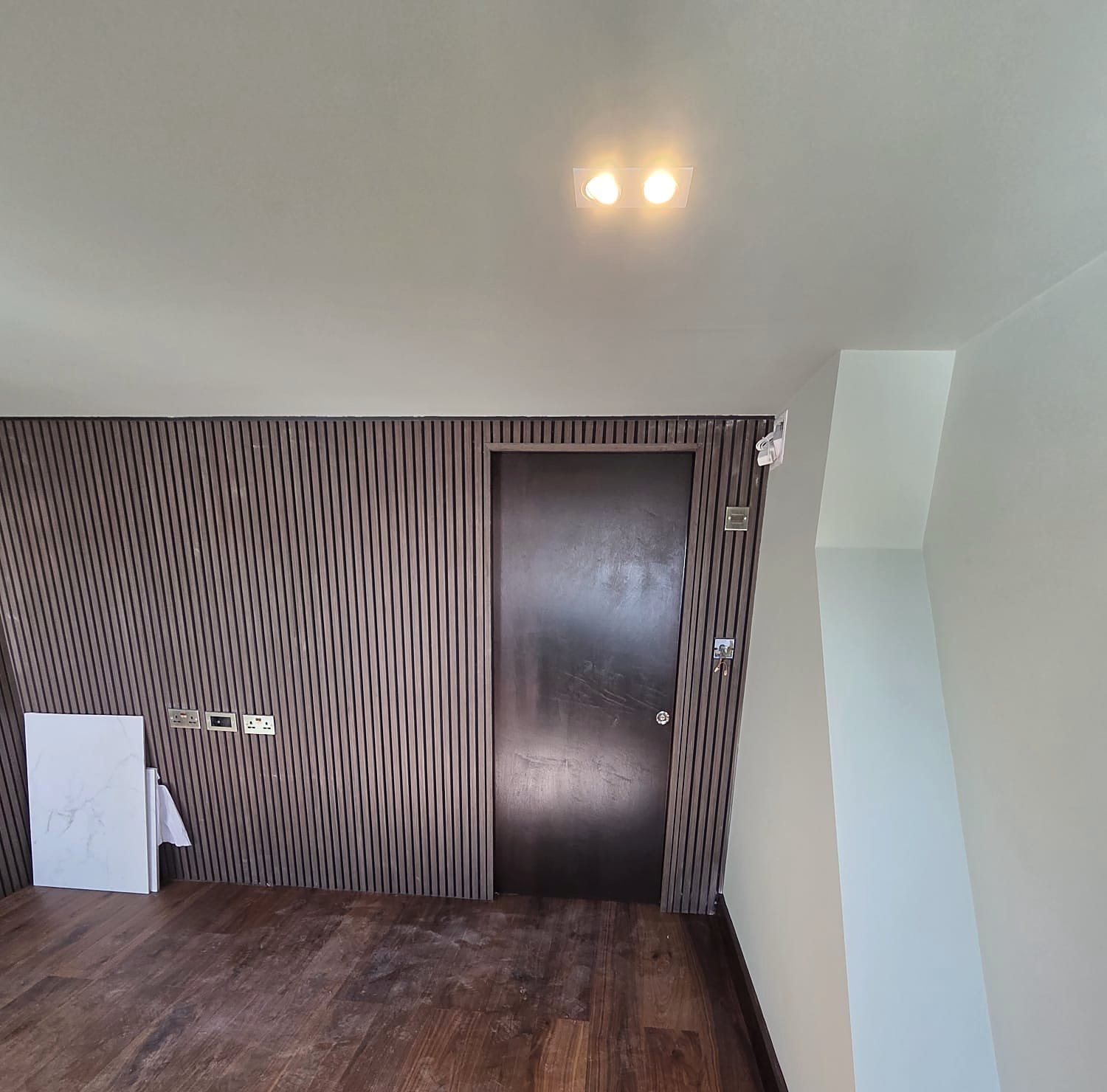 Loft room with walnut slat wall, painted by Zakro